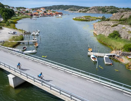 Two bikers riding over a bridge in Norway