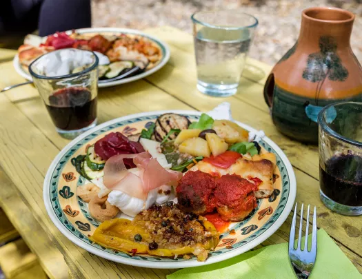 Platter of food, cheese, cured meats, meatballs, fruits, etc.