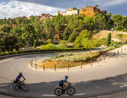Guests cycling towards hilltop castle. 