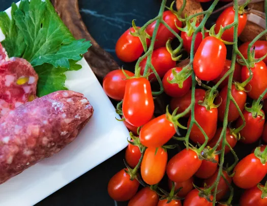 Close-up of cherry tomatoes and salami.