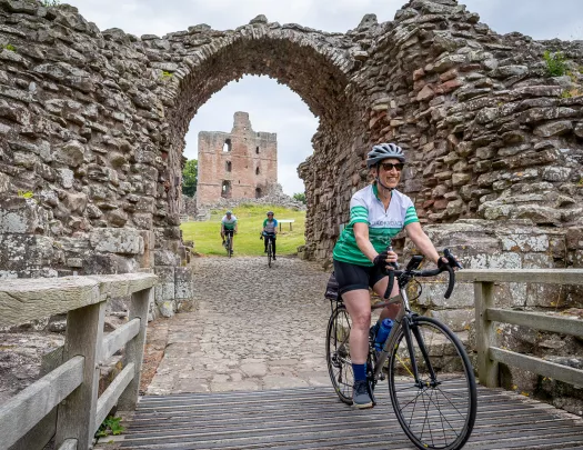 3 Guests Riding Cobblestone Under Old Arch Scotland