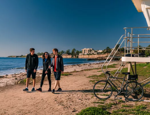 People walking along California beach.