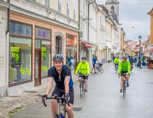 Bikers riding down a street in Slovenia