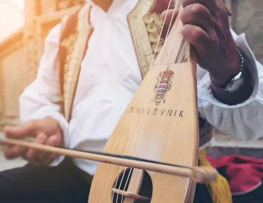 Close-up of local playing string instrument.
