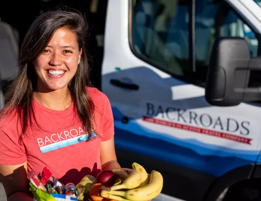 Backroads leader offering fruit on trip