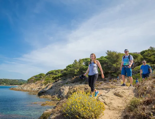 Group of three Backroads guests hiking beside the sea in France
