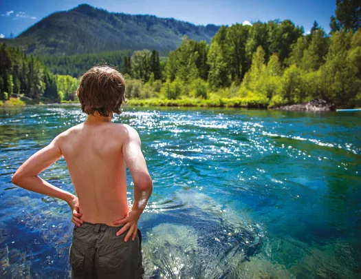Backroads guest looking out at blue water and mountains
