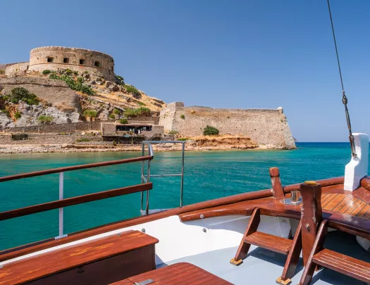 POV shot on boat, looking towards Spinalonga fortress.