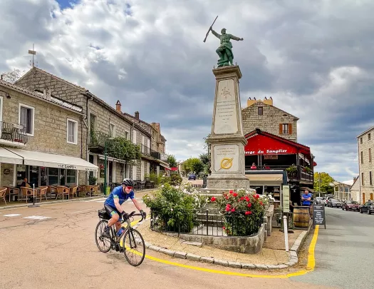 Guest cycling through town square in Zonza.