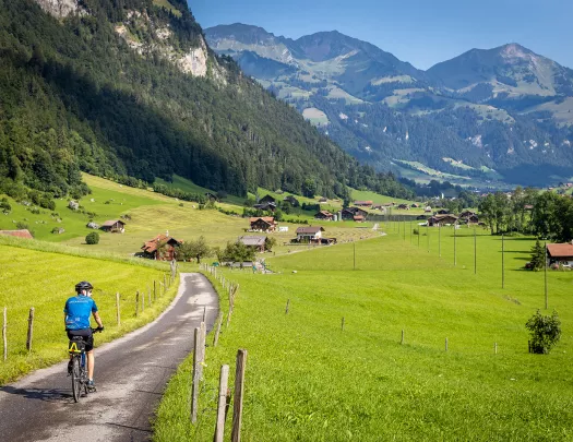 Guest cycling towards mountain village.