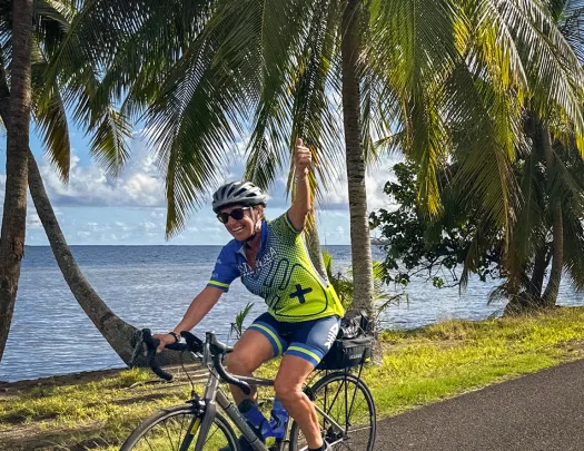 Biking along a palm tree lined shore in Tahiti