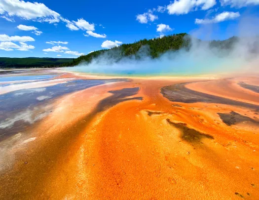 Orange sand leading up to smoking hot springs 