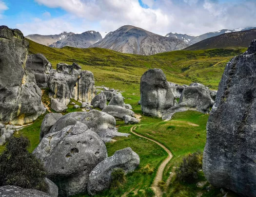 Winding path among large rocks and boulders in New Zealand