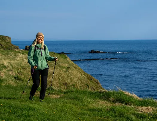 Hiker posing on a rock, clifside.