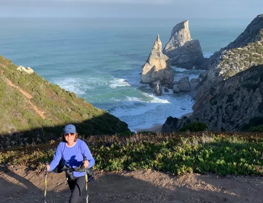 A woman walking along the coast