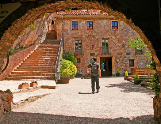Archway shot of guest amid red brick courtyard.