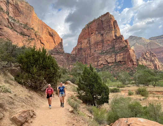 Hikers walking on trail in canyon