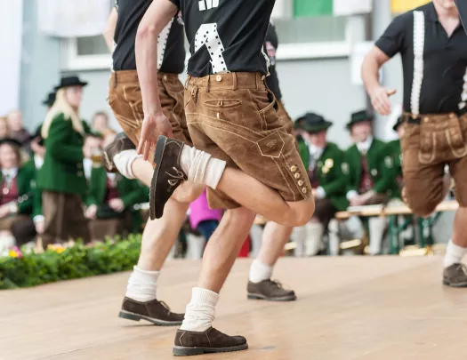 Young men doing an Austrian traditional folk dance.