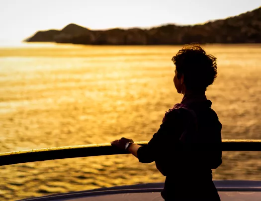 Person on a beach looking into the sunset
