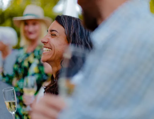 Woman smiling while holding up a glass of wine