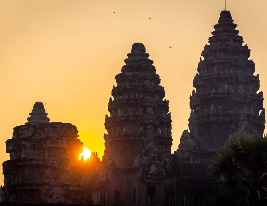 Sun setting behind stone temples