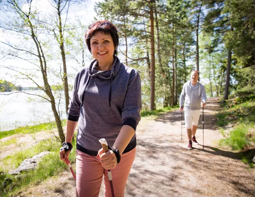 Male and female hiker with walking sticks