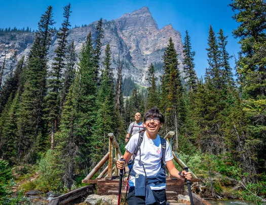 Backroads guest hiking across a bridge