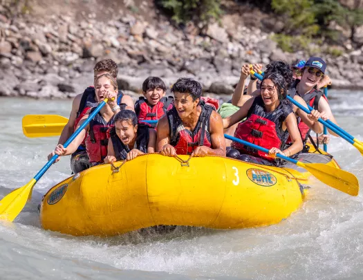 teens on a raft in the river