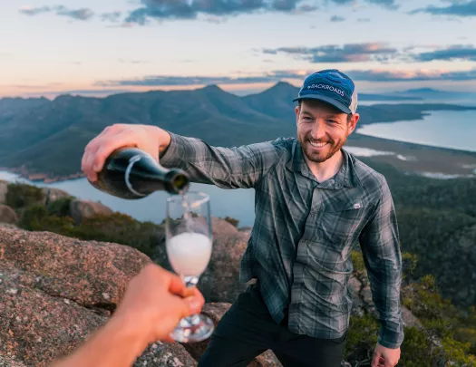 Man pouring alcohol into a small glass