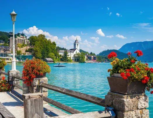 A bridge with pink flowers overlooking water