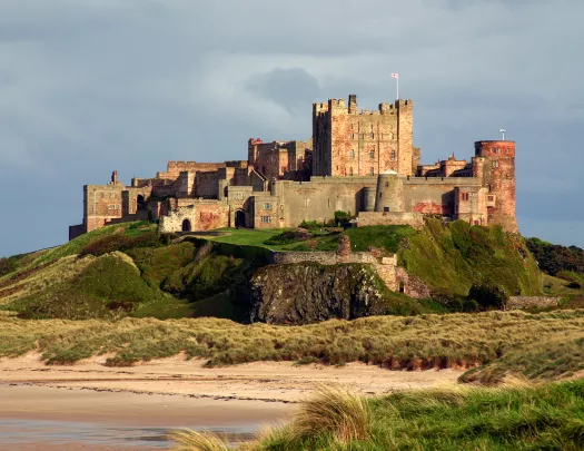 castle on a hill by a beach