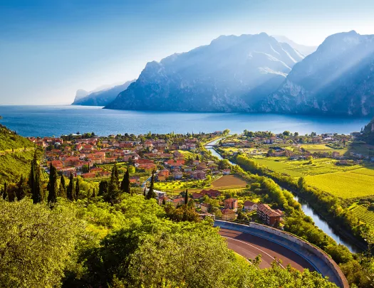 Small oceanside town with crop fields and mountains