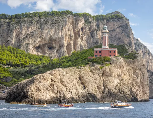 Light house on a rocky cliff by the ocean