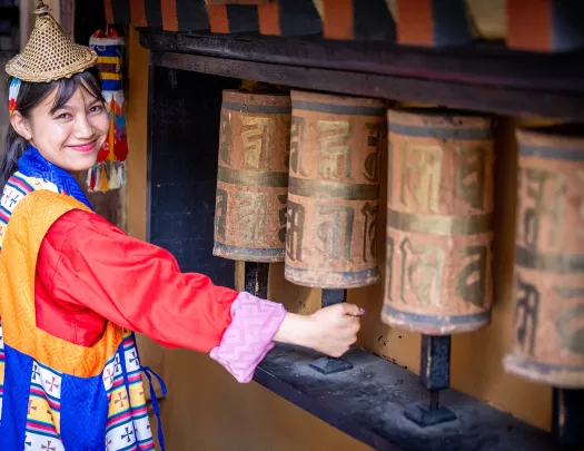 Woman in a traditional dress, walking through a temple