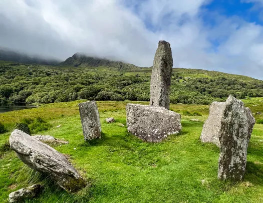 six large rocks in a grassy field