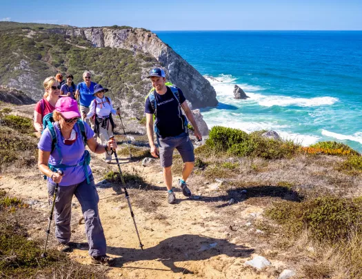 Hikers walking up a shoreline trail