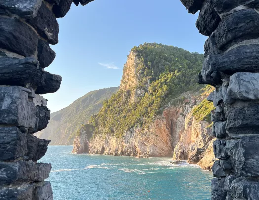 Archway made of stone, looking out towards the ocean