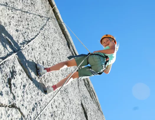 Child belaying from a wall using rope