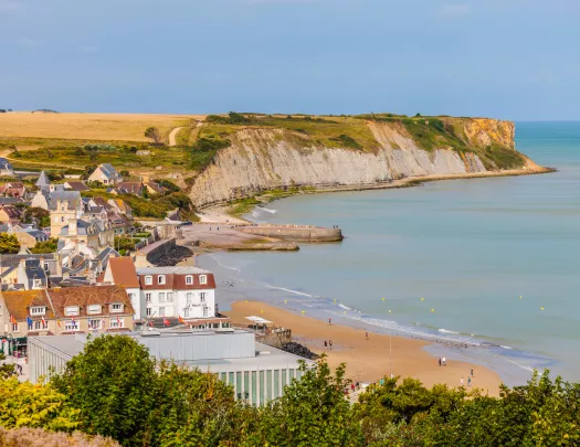 Small town next to a beach and large cliffs