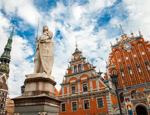 Latvian attraction - house of the Blackheads, sculpture of Saint Roland and Saint Peters Church in old city Riga, Latvia