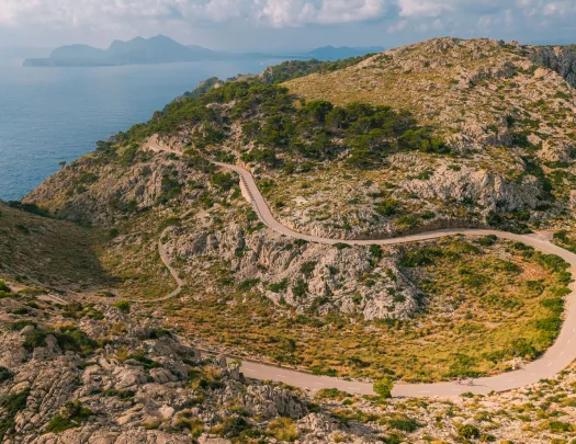 Long, sharp-turned road on an open valley