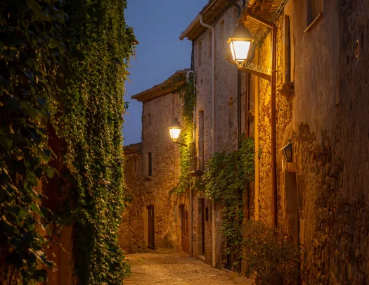 Nighttime view of an alleyway along stone buildings