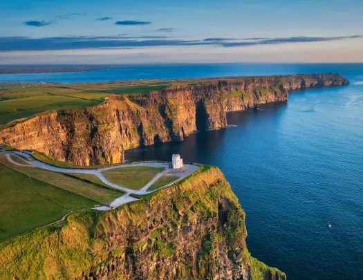 Lighthouse on top of a cliff with the ocean on the ground floor