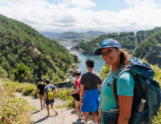 Group of people hiking with a woman turning around and smiling