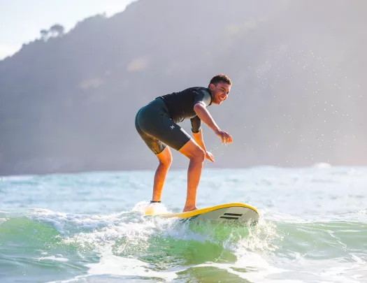 Man standing on a surfboard in the ocean