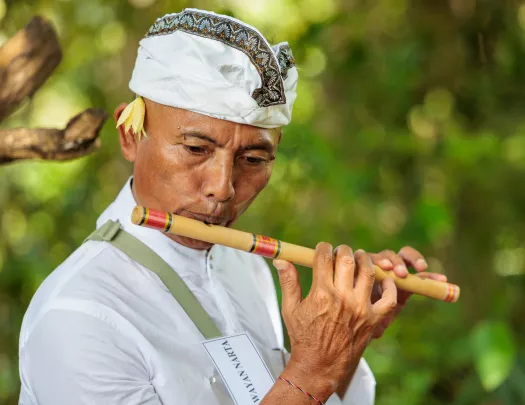 Man playing a wooden flute