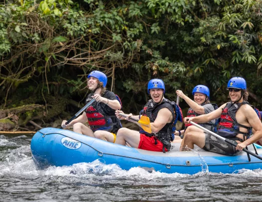 Three Backroads guests whitewater rafting