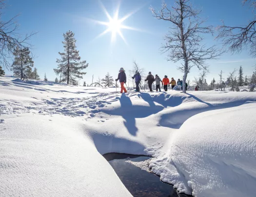 Group of people walking in a valley of snow