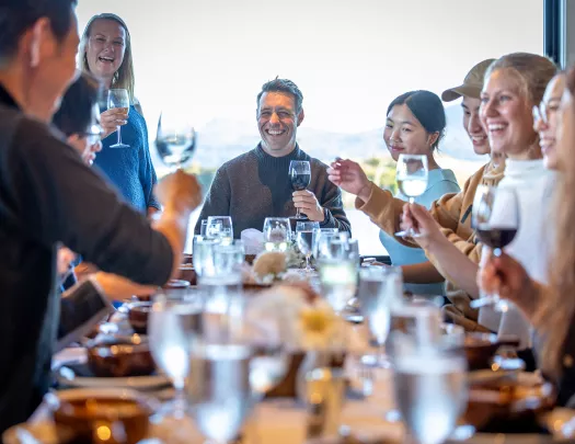Backroads guests gather celebrate around a dinner table