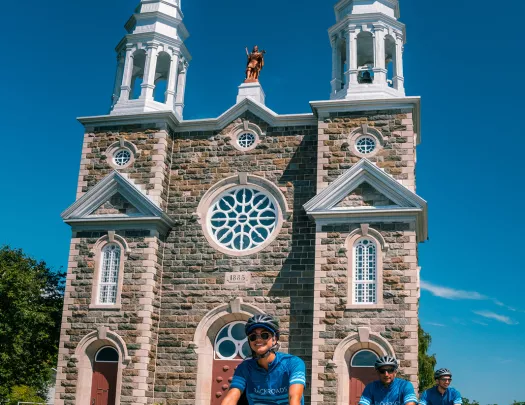 Backroads guests cycle in front of a church